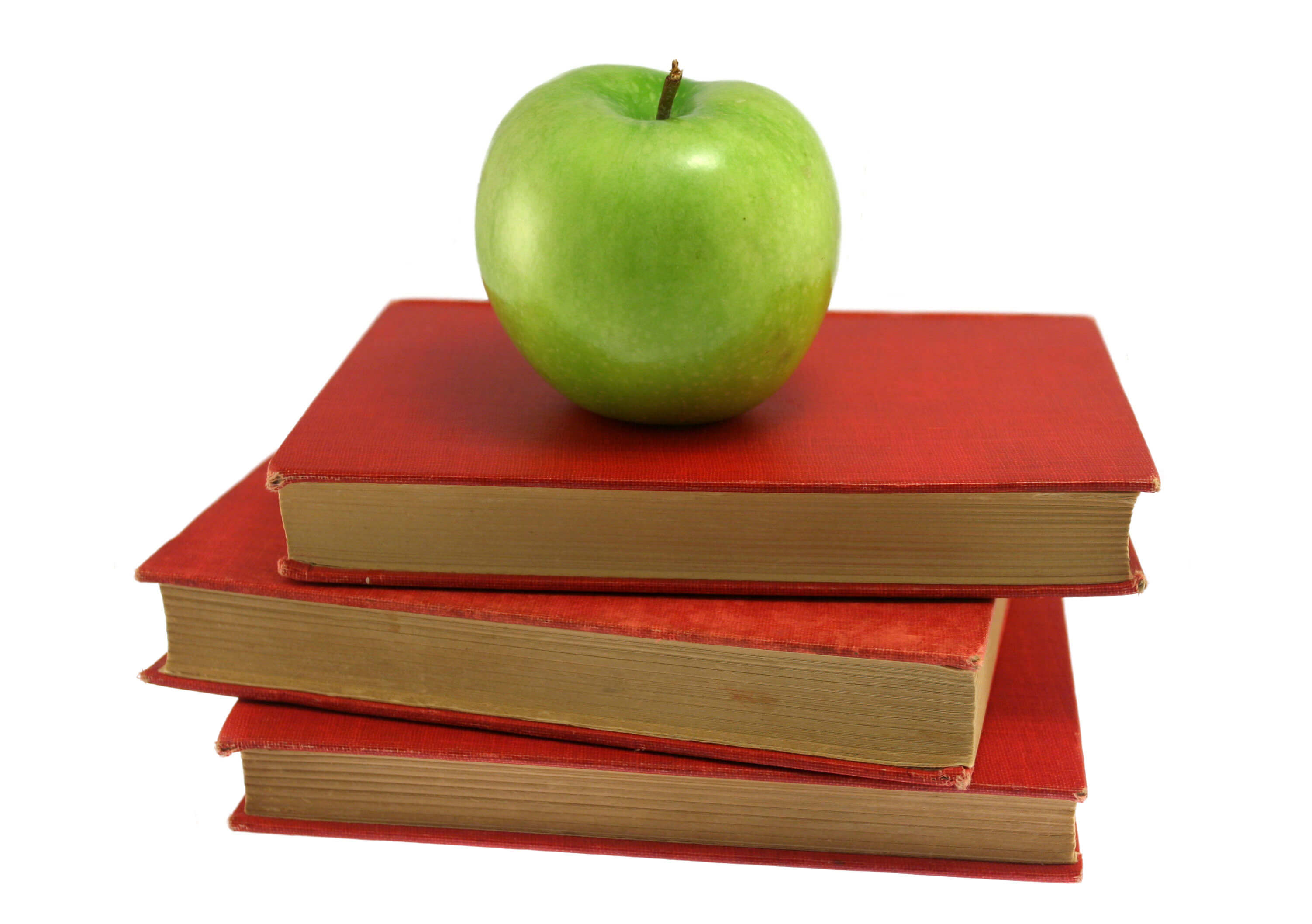 Green apple on stack of red books.